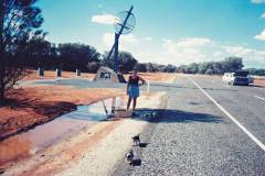 Cooling Tara'a puppies off in puddles driving through the centre of Australia in a 1965 HR Holden