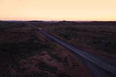 A roadtrain on the highway in the Pilbara near Whim Creek WA at dusk in 2019