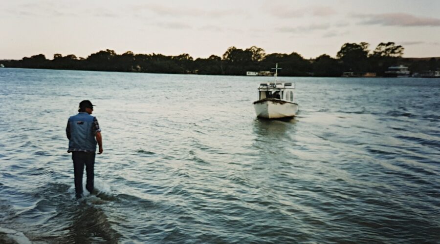 Fred aiding his old boat, Huck Finn