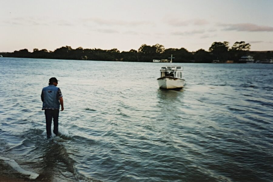 Fred aiding his old boat, Huck Finn