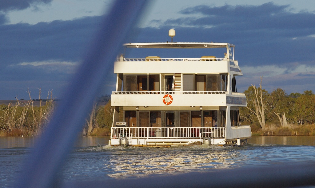 Large houseboat underway