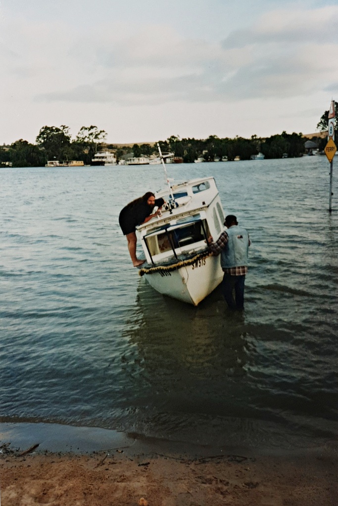 Fred inspecting the damage to the boat